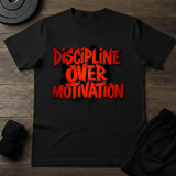 Discipline Over Motivation T-Shirt featuring bold, red graphic text on a black background, promoting commitment and focus.