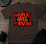 Discipline Over Motivation T-Shirt on brown fabric, emphasizing the importance of discipline in achieving success.